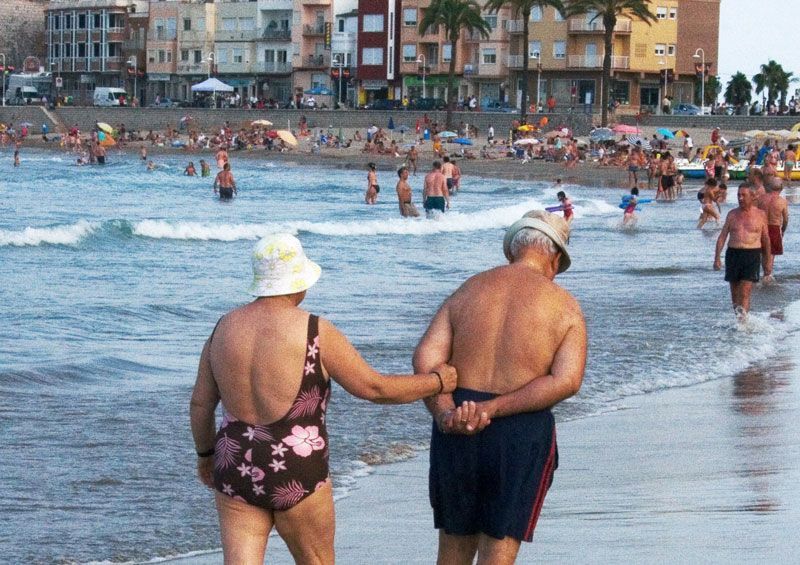 Una pareja de veraneantes ancianos pasean por la playa | Foto: M. Coheh bajo licencia Creative Commons